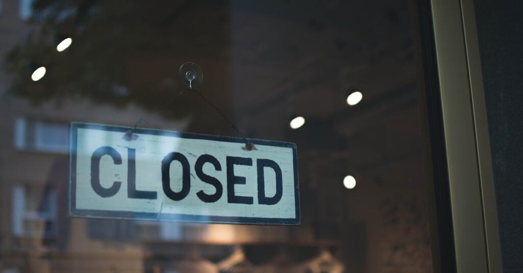 pexels-photo-1793031-1793031 A closed sign hangs on a glass window of a modern urban storefront.